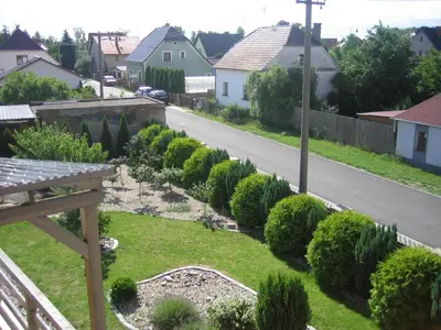 a view of a garden from the balcony of a house at Apartmány Polepy in Polepy