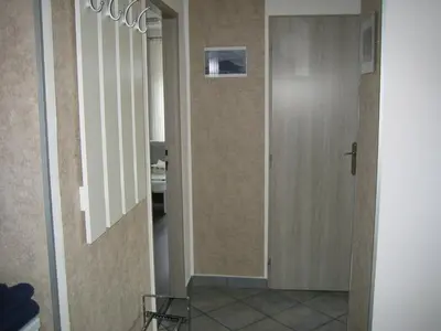 a hallway with a door and a mirror at Apartmány Polepy in Polepy