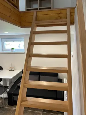 an office with a ladder leading up to a desk at Zahradní dům in Prague