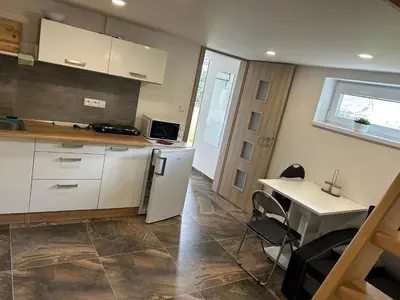 a kitchen with a white refrigerator and a table at Zahradní dům in Prague