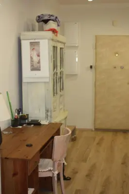 a room with a wooden desk and a door at Lovely And Freshly Renovated Apartment In Praha 10 in Prague
