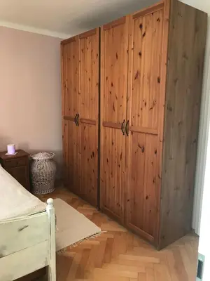 a bedroom with wooden cabinets and a bed at Lovely And Freshly Renovated Apartment In Praha 10 in Prague