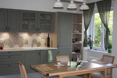a kitchen with a table and a sink and a counter at Lovely And Freshly Renovated Apartment In Praha 10 in Prague