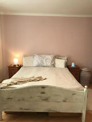 a large bed in a bedroom with two night stands at Lovely And Freshly Renovated Apartment In Praha 10 in Prague