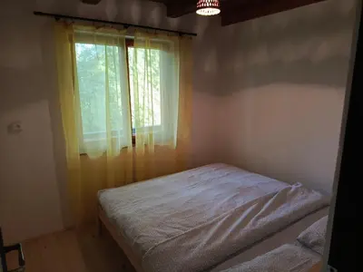 a bedroom with a bed and a window at Slapy chata Županovice in Županovice