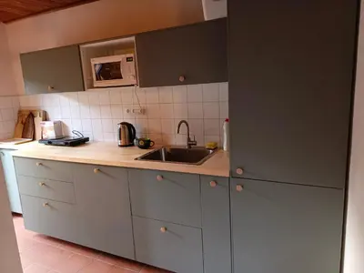 a kitchen with a sink and a microwave at Slapy chata Županovice in Županovice