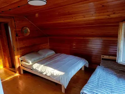 a bedroom with a bed in a wooden cabin at Slapy chata Županovice in Županovice