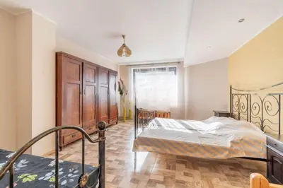 a bedroom with a bed and a staircase at Okouzlující vila u jezera Lhota in Lhota
