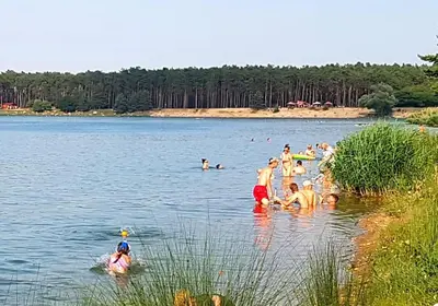 a group of people swimming in a lake at Okouzlující vila u jezera Lhota in Lhota