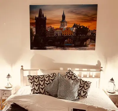 a bedroom with a bed with a painting on the wall at TOP lokalita u Pražského hradu! in Prague