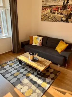 a living room with a couch and a coffee table at TOP lokalita u Pražského hradu! in Prague