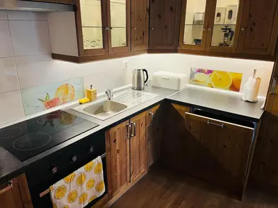 a kitchen with wooden cabinets and a sink at TOP lokalita u Pražského hradu! in Prague