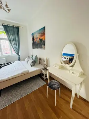 a bedroom with a bed and a mirror and a desk at TOP lokalita u Pražského hradu! in Prague