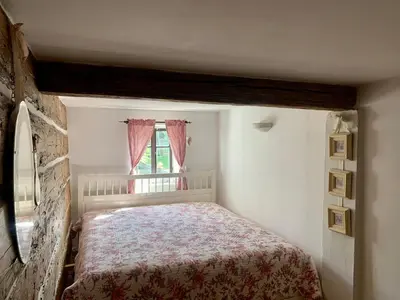 a small bedroom with a bed and a window at Bezva relax Bezděz in Luka