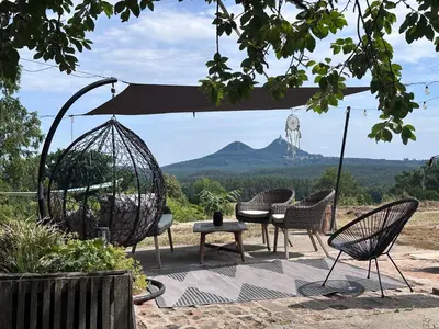 a patio with chairs and a swing and a table at Bezva relax Bezděz in Luka