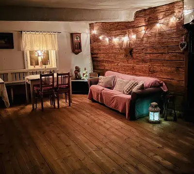 a living room with a bed and a table and a dining room at Bezva relax Bezděz in Luka
