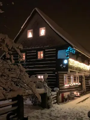 a log cabin with christmas lights on it at Bezva relax Bezděz in Luka