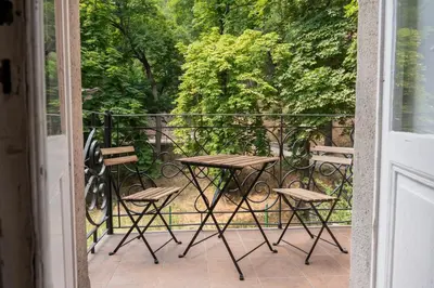 a patio with a table and chairs on a balcony at WSP Petrin Garden Apartments in Prague