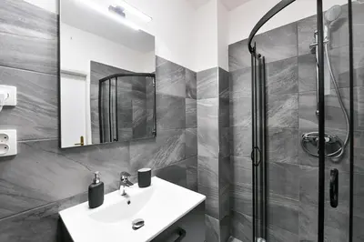 a bathroom with a sink and a shower at WSP Petrin Garden Apartments in Prague