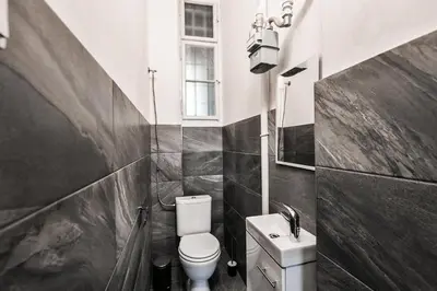 a black and white bathroom with a toilet and a sink at WSP Petrin Garden Apartments in Prague