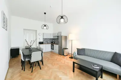 a living room with a blue couch and a table at WSP Petrin Garden Apartments in Prague