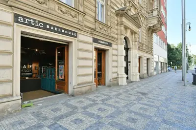 an empty street with a store in a building at WSP Petrin Garden Apartments in Prague