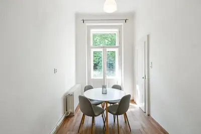 a white dining room with a table and chairs at WSP Petrin Garden Apartments in Prague