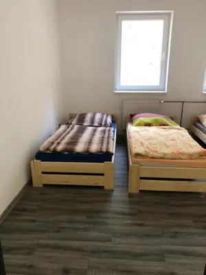 two twin beds in a room with a window at UBYTOVNA SK Posázavan Poříčí nad Sázavou in Poříčí nad Sázavou