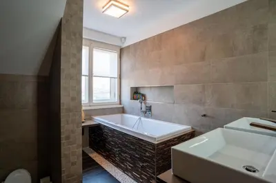 a bedroom with a bed and a window at Luxury rooftop appartment with fantastic views in Prague