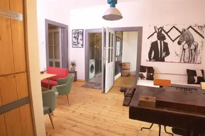 a living room with a couch and a table at Artistic apartment with a balcony in Prague
