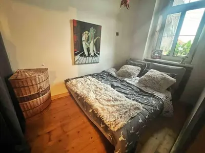 a bedroom with a bed with a comforter and pillows at Artistic apartment with a balcony in Prague