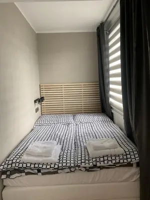 a bedroom with a bed with two pillows on it at Studio Prosek in Prague