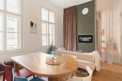 a living room with a wooden table and chairs at Prague Days - Spacious City Center Studios next to the Powder Tower in Prague