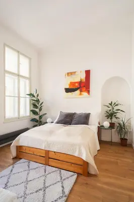 a bedroom with a bed in a white room at Prague Days - Spacious City Center Studios next to the Powder Tower in Prague