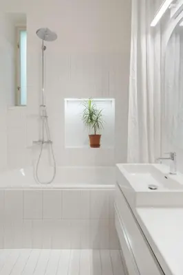 a bathroom with a tub and a sink and a plant at Prague Days - Spacious City Center Studios next to the Powder Tower in Prague