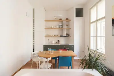 a kitchen and dining room with a wooden table and chairs at Prague Days - Spacious City Center Studios next to the Powder Tower in Prague