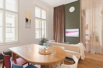 a living room with a table and chairs at Prague Days - Spacious City Center Studios next to the Powder Tower in Prague