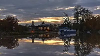 a house on a lake with a boat in the water at Solitaire in Poděbrady