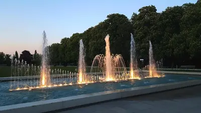 a fountain with lights in a park at dusk at Solitaire in Poděbrady
