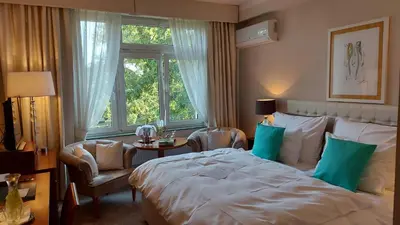 a bedroom with a bed and a chair and a window at Solitaire in Poděbrady