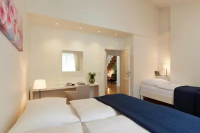 a bedroom with a bed and a desk in it at Residence Vocelova in Prague