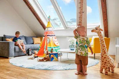a child standing in a living room with toys at Residence Vocelova in Prague
