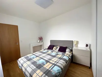 a bedroom with a bed with a plaid bedspread at Apartment with Free Parking in Prague in Prague