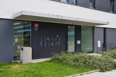 an office building with a black door and windows at Apartment with Free Parking in Prague in Prague