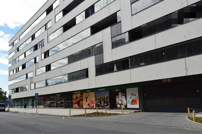a large white building on the side of a street at Apartment with Free Parking in Prague in Prague