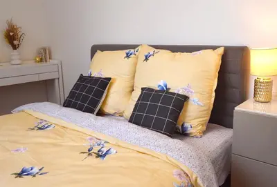 a bed with pillows with blue flowers on it at Apartment with Free Parking in Prague in Prague