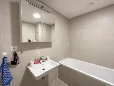 a bathroom with a sink and a tub and a mirror at Apartment with Free Parking in Prague in Prague