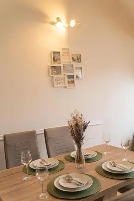 a dining room table with plates and wine glasses at FREE PARKING- Cozy apartment in historical building center Prague in Prague