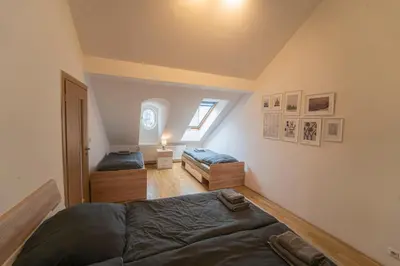 a attic bedroom with two beds and a window at FREE PARKING- Cozy apartment in historical building center Prague in Prague