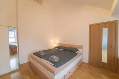 a bedroom with a bed in a room with a door at FREE PARKING- Cozy apartment in historical building center Prague in Prague